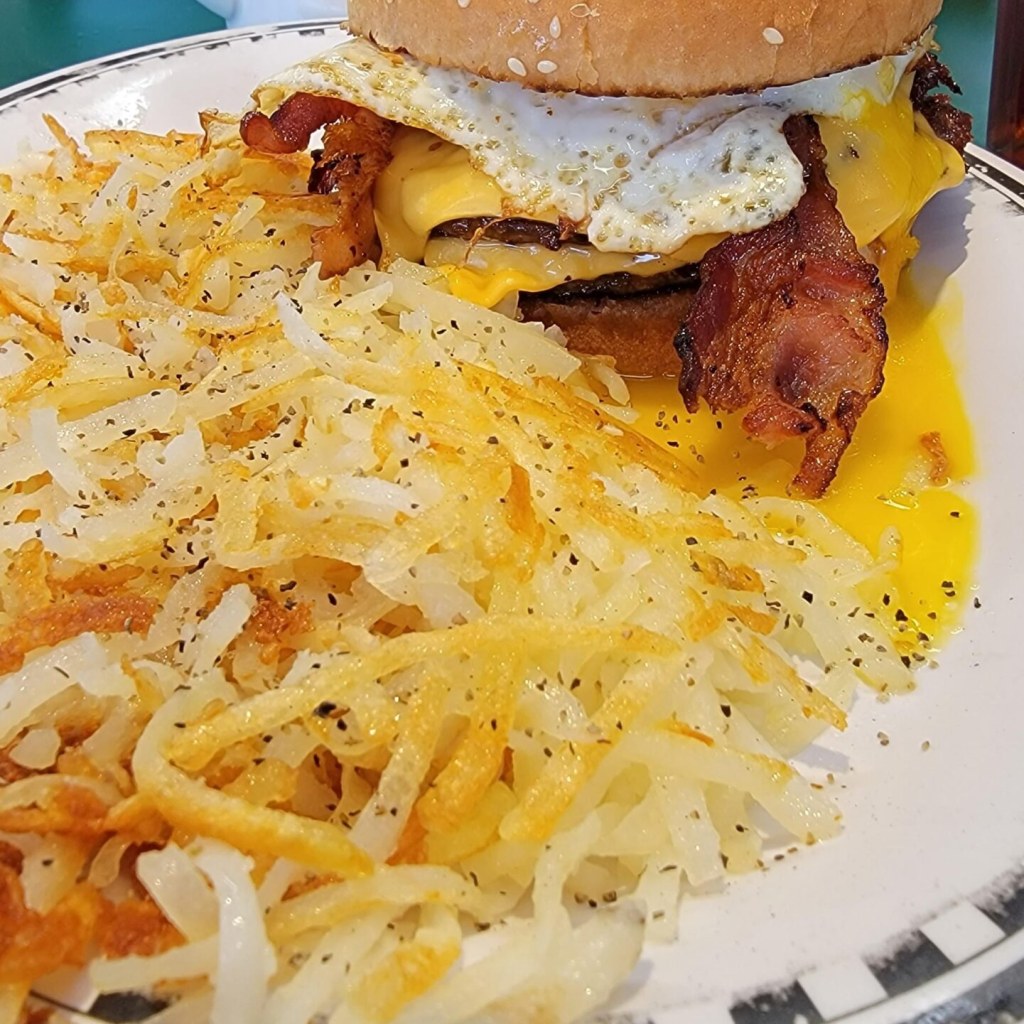 “Indulge in a Delicious Bacon Double Cheeseburger with Egg and Crispy Hashbrowns!”
